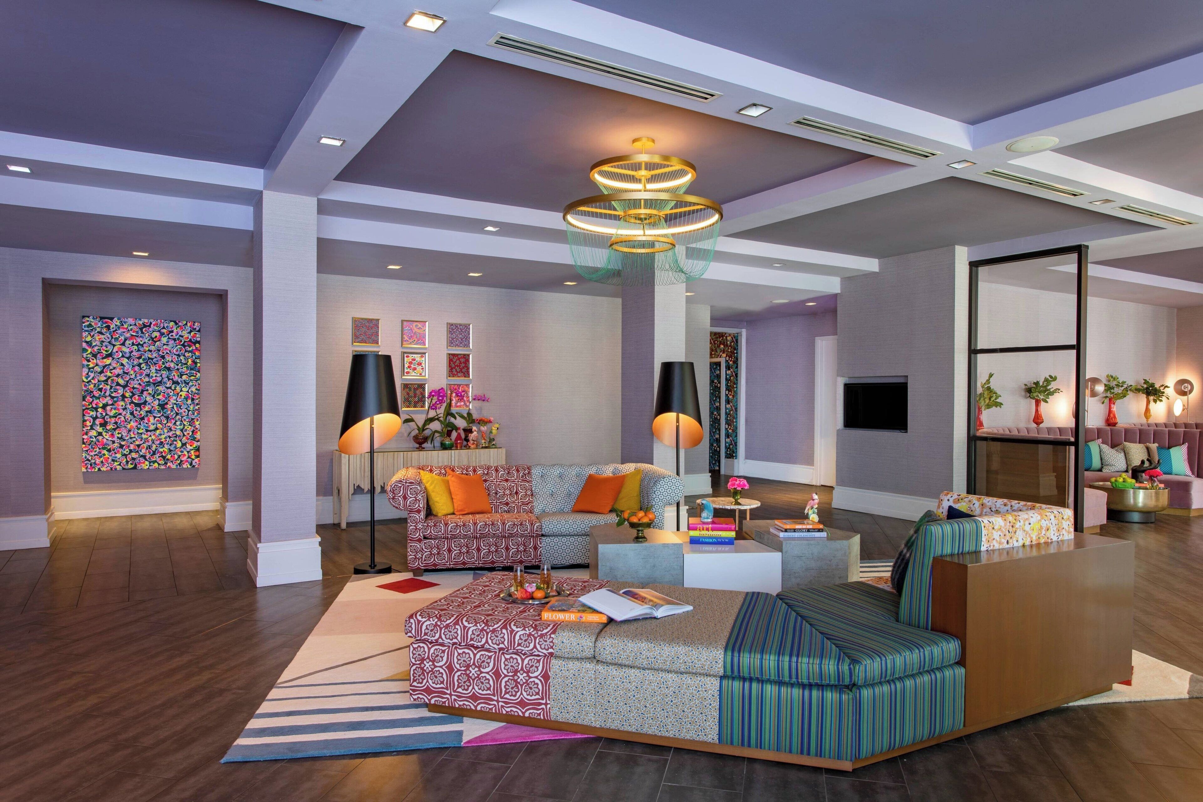 A modern living room with a sofa set, a coffee table, and a decorative lamp.