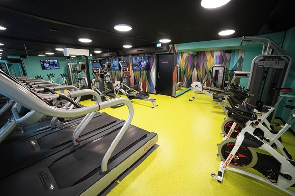 A gym with treadmills, ellipticals, and weight machines.
