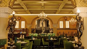 A grand interior with ornate ceiling, green carpet, and classical statues. - Hotel Bristol (Oslo)