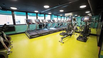 A gym with treadmills, ellipticals, and weight machines.