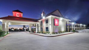 A hotel with a red roof, a clock tower, and a sign for 'Red Roof Plus'. - Red Roof Inn PLUS+ Dallas – Addison (Addison)