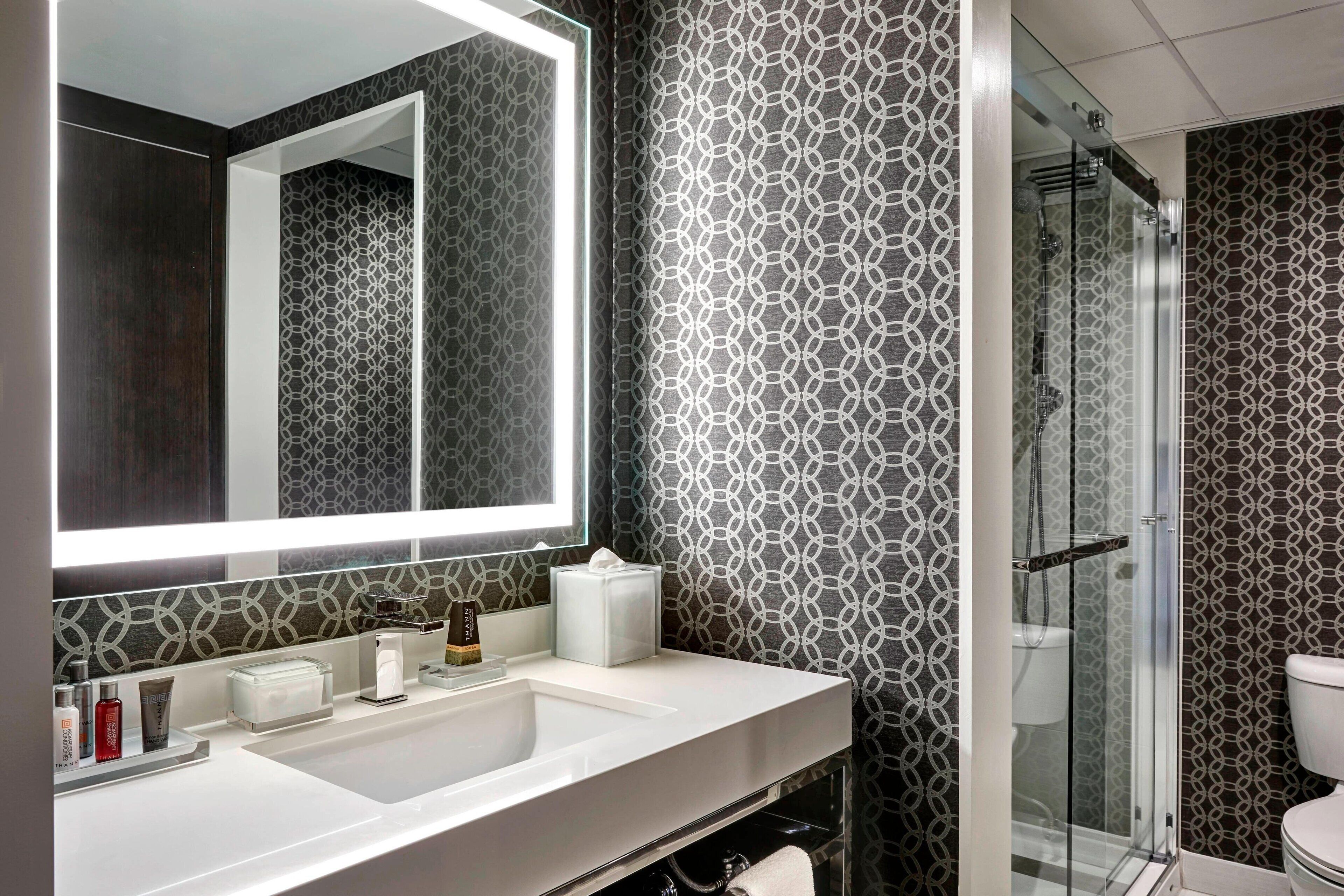 combined shower/bathtub, designer toiletries, hair dryer, towels