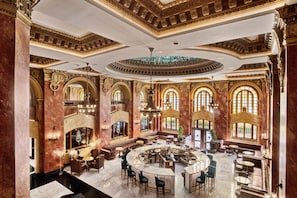 A luxurious interior with a central bar, seating areas, and ornate architectural details. - Hotel Paso Del Norte, Autograph Collection (El Paso)