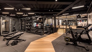 A gym with various exercise equipment, including treadmills, weight machines, and free weights. - Radisson Blu Hotel, London Heathrow (Hayes)