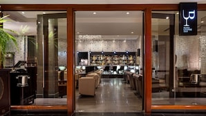 A bar area with seating and a bar counter. - Radisson Blu Hotel, London Heathrow (Hayes)