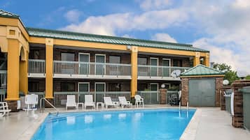 Guests can enjoy a refreshing dip in the pool surrounded by comfortable lounge chairs and a shaded seating area.