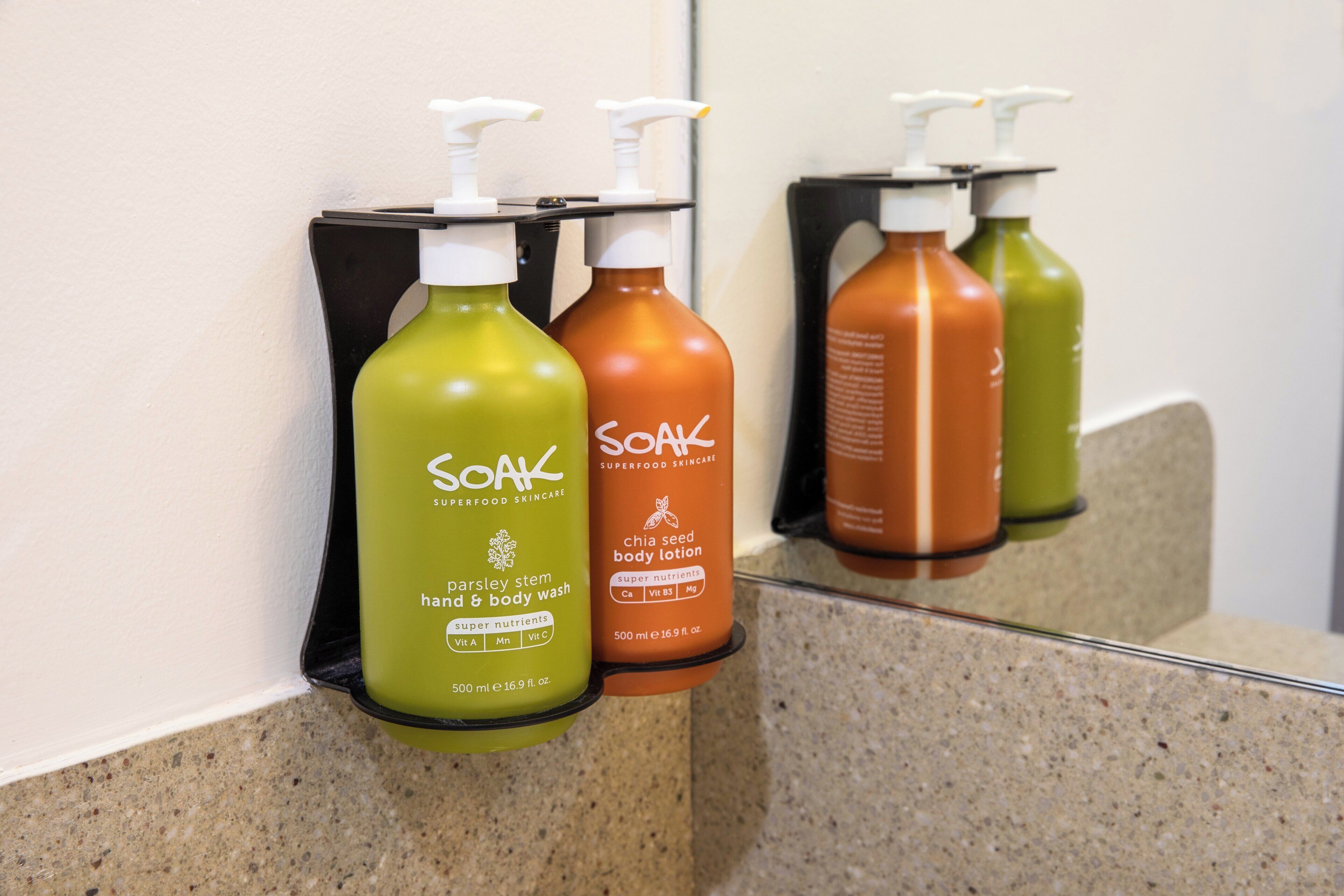 Tres botellas de Soak Superfood Skincare sobre una encimera.