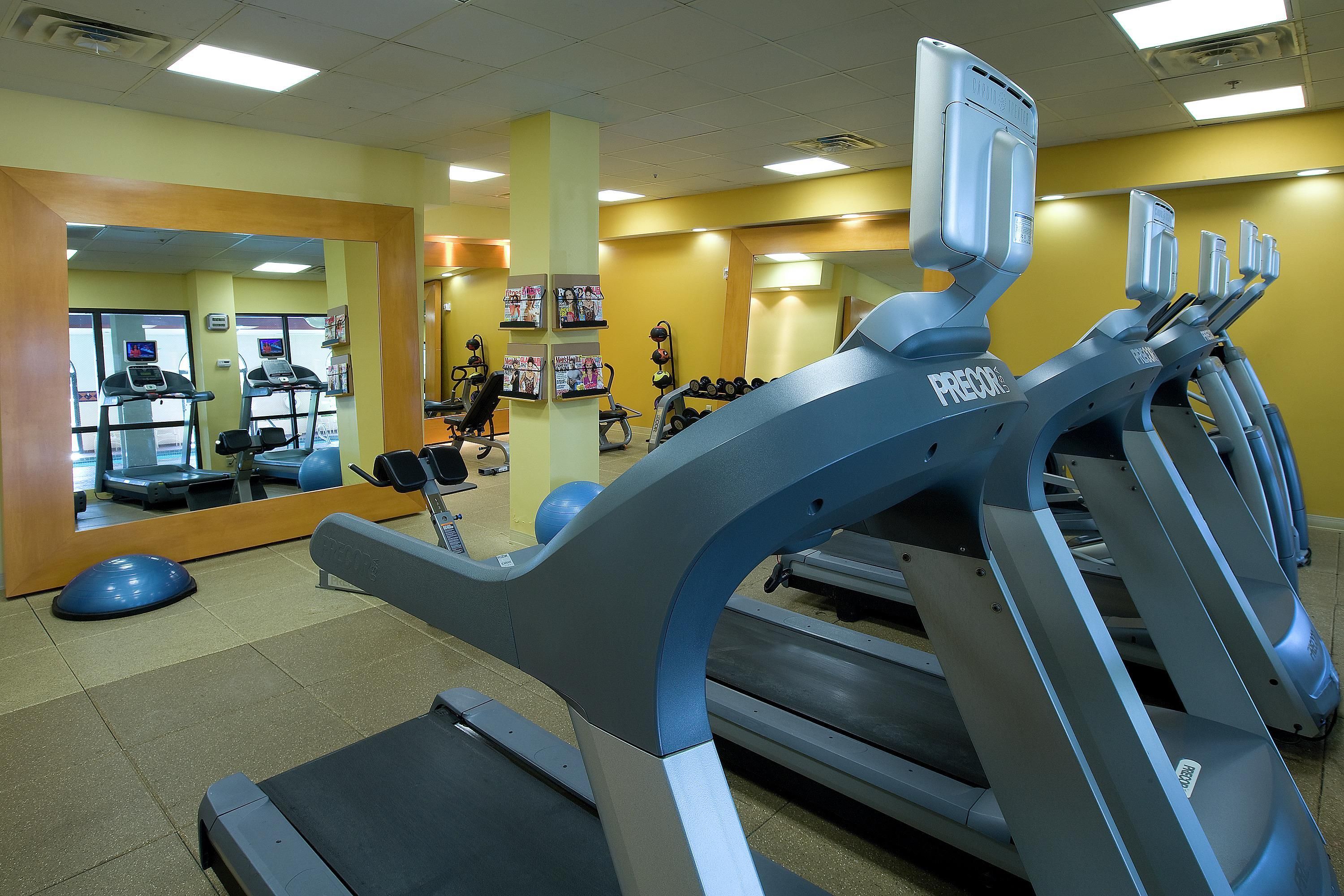 A gym with treadmills, exercise balls, and weight machines.