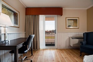 Enjoy a comfortable stay with a desk, sofa, and bed, plus a view of the outdoors through a sliding glass door.