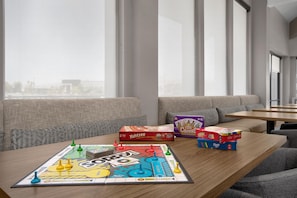 A board game setup on a table with a sofa and a window in the background. - Homewood Suites by Hilton Santa Maria (Santa Maria)