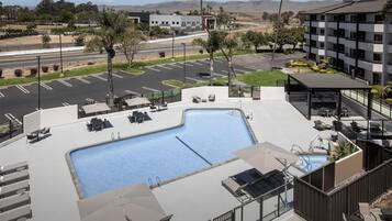 Outdoor pool, open 9:00 AM to 10:00 PM, pool umbrellas, pool loungers