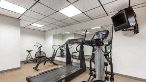 A gym with treadmills, elliptical machines, and a stationary bike. - Lamplighter Inn & Suites - North (Springfield)