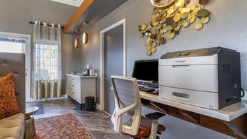 A modern office space with a printer, office chair, and desk.
