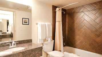 A bathroom with a sink, toilet, and bathtub.