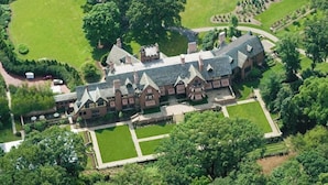 An aerial view of a large, historic building with multiple wings and a central courtyard. - Copley Inn & Suites By OYO Akron OH (Akron)