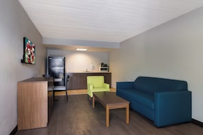 A compact living space with a kitchenette, a dining area, and a seating area.