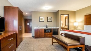 A hotel room with a bed, a bench, a TV, a kitchenette, and a bathroom. - Comfort Inn Ottawa Starved Rock Area (Ottawa)