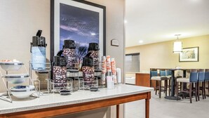 A hotel reception area with a coffee station, seating area, and a framed picture on the wall. - Comfort Inn Ottawa Starved Rock Area (Ottawa)