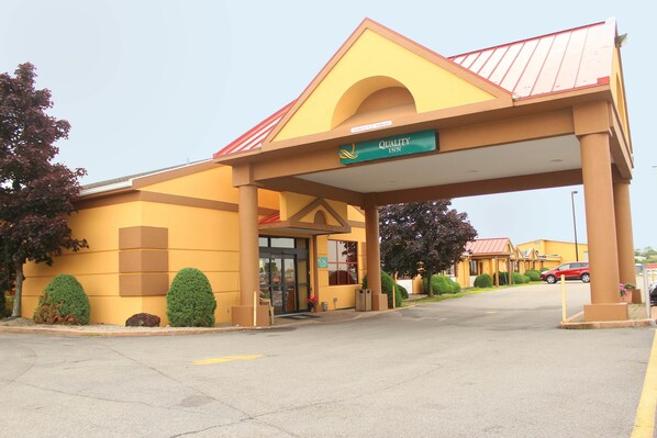 A yellow building with a green sign reading "Quality Inn."