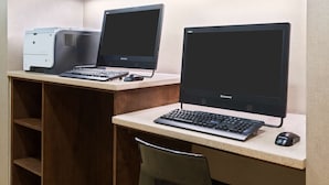 A workspace with two monitors, a desktop computer, and a keyboard. - Hampton Inn Charlotte - University Place (Charlotte)