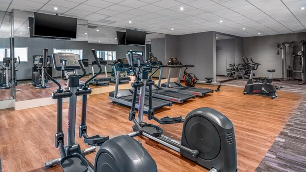 A gym with various cardio and strength training equipment, including treadmills, elliptical machines, and weight machines. - Holiday Inn Hyannis by IHG (Hyannis)
