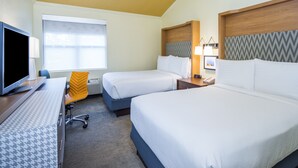 A hotel room with two beds, a desk with a computer, a chair, and a window with curtains. - Holiday Inn Hyannis by IHG (Hyannis)