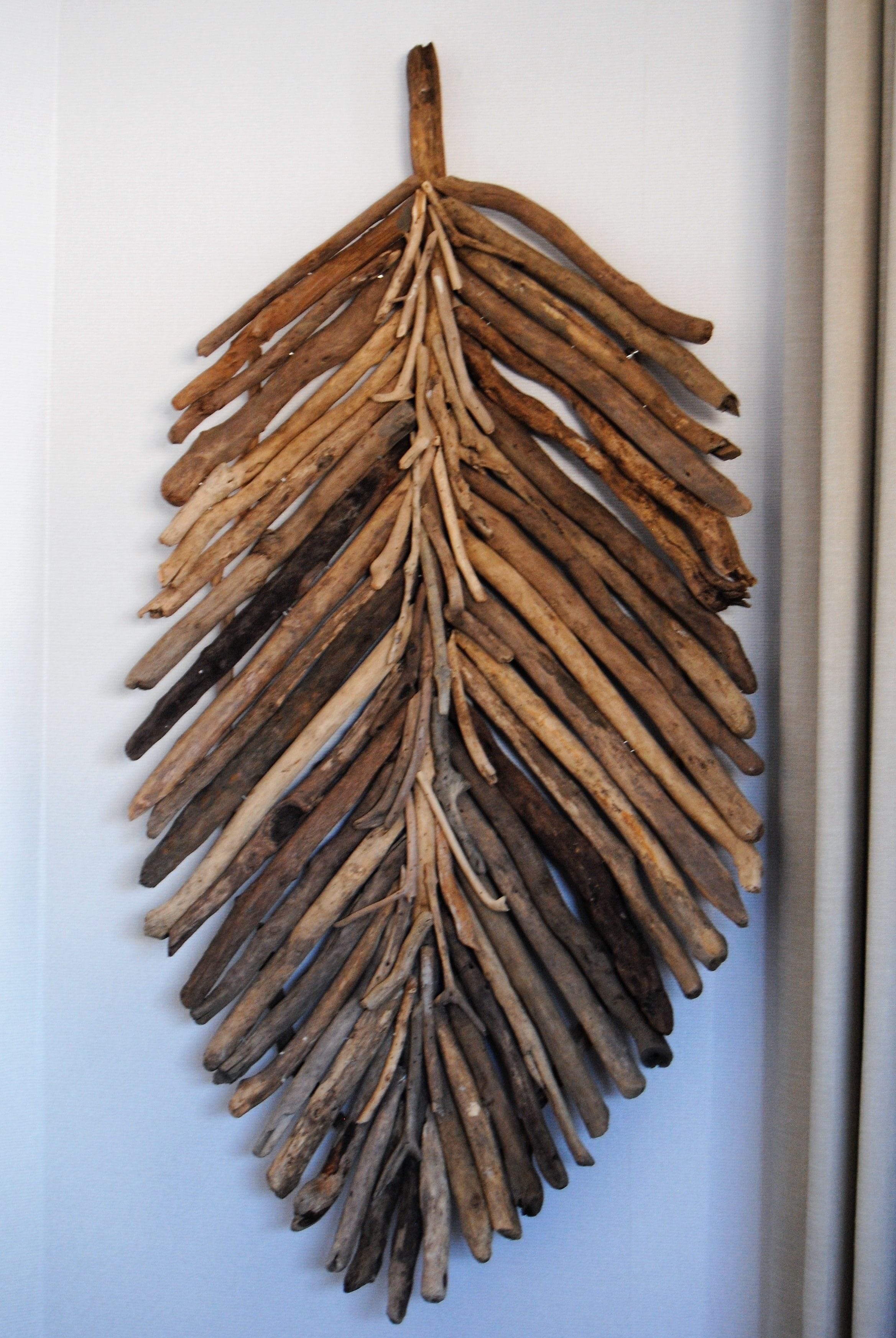 A wall-mounted wooden leaf sculpture.