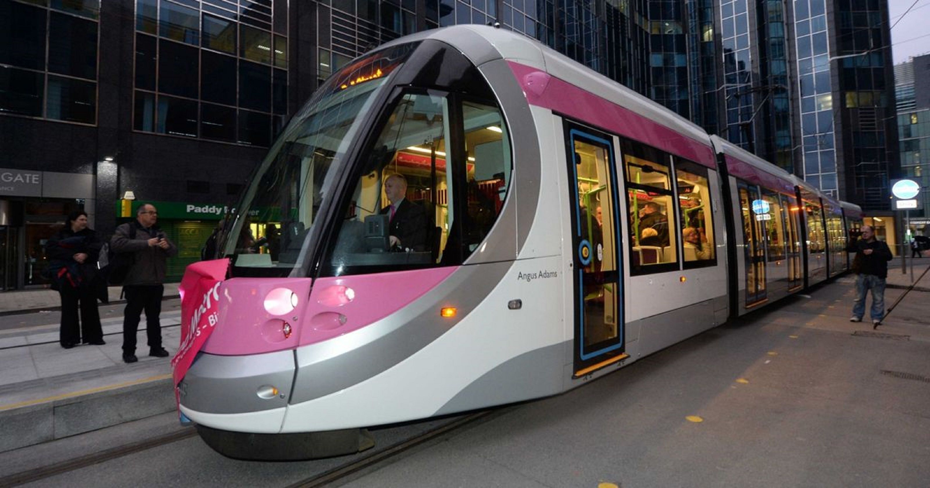 A modern train with a sleek design, a driver’s cabin, and passenger windows.