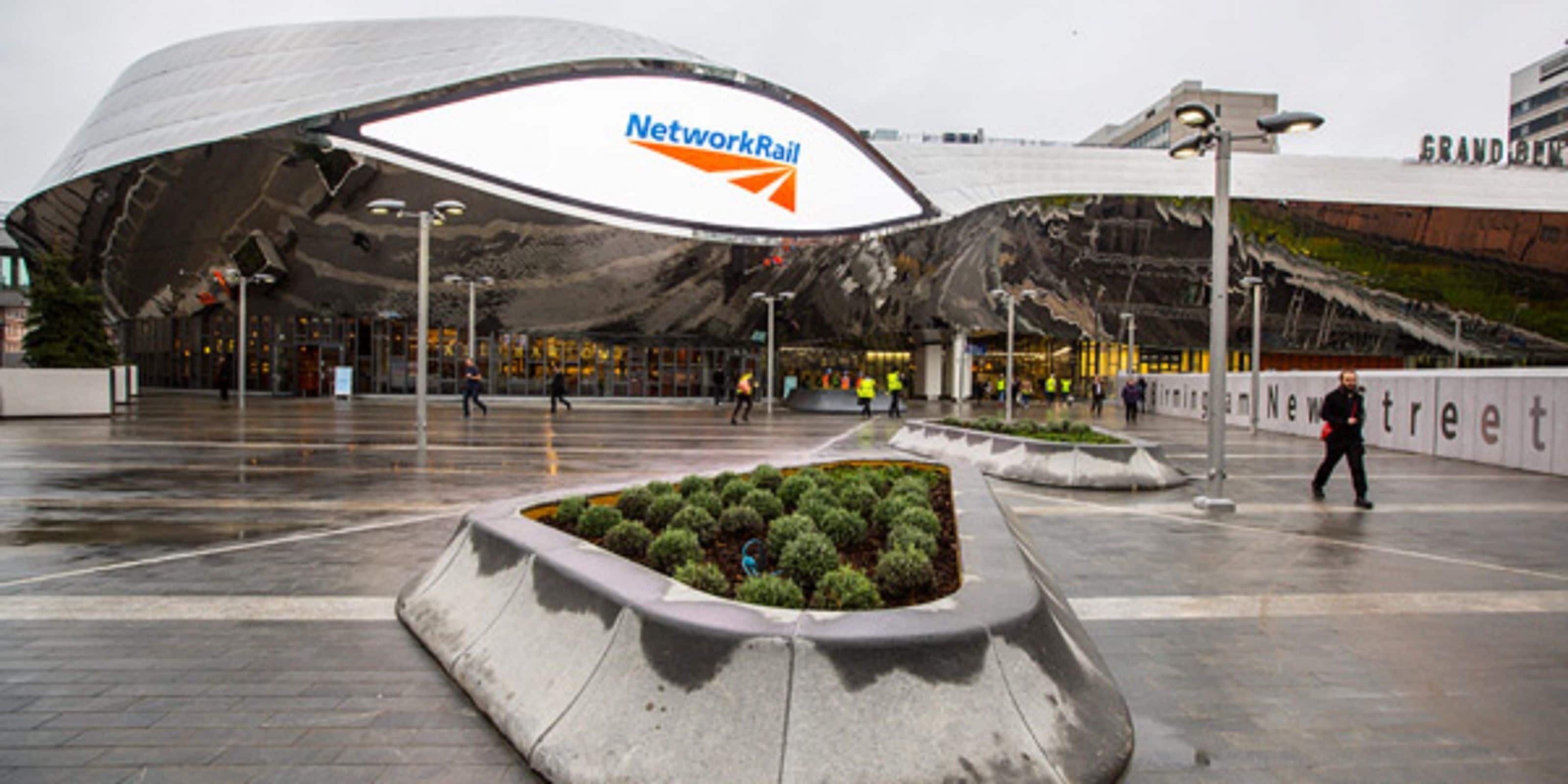 A modern building with a curved roof and a sign that reads "Network Rail".