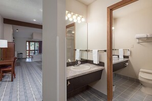 A modern bathroom with a vanity, sink, and toilet.