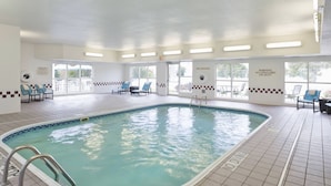 An indoor swimming pool with clear water, a no diving sign, and a tiled floor. - PrimeStay Extended Suites by IHG (Madison)