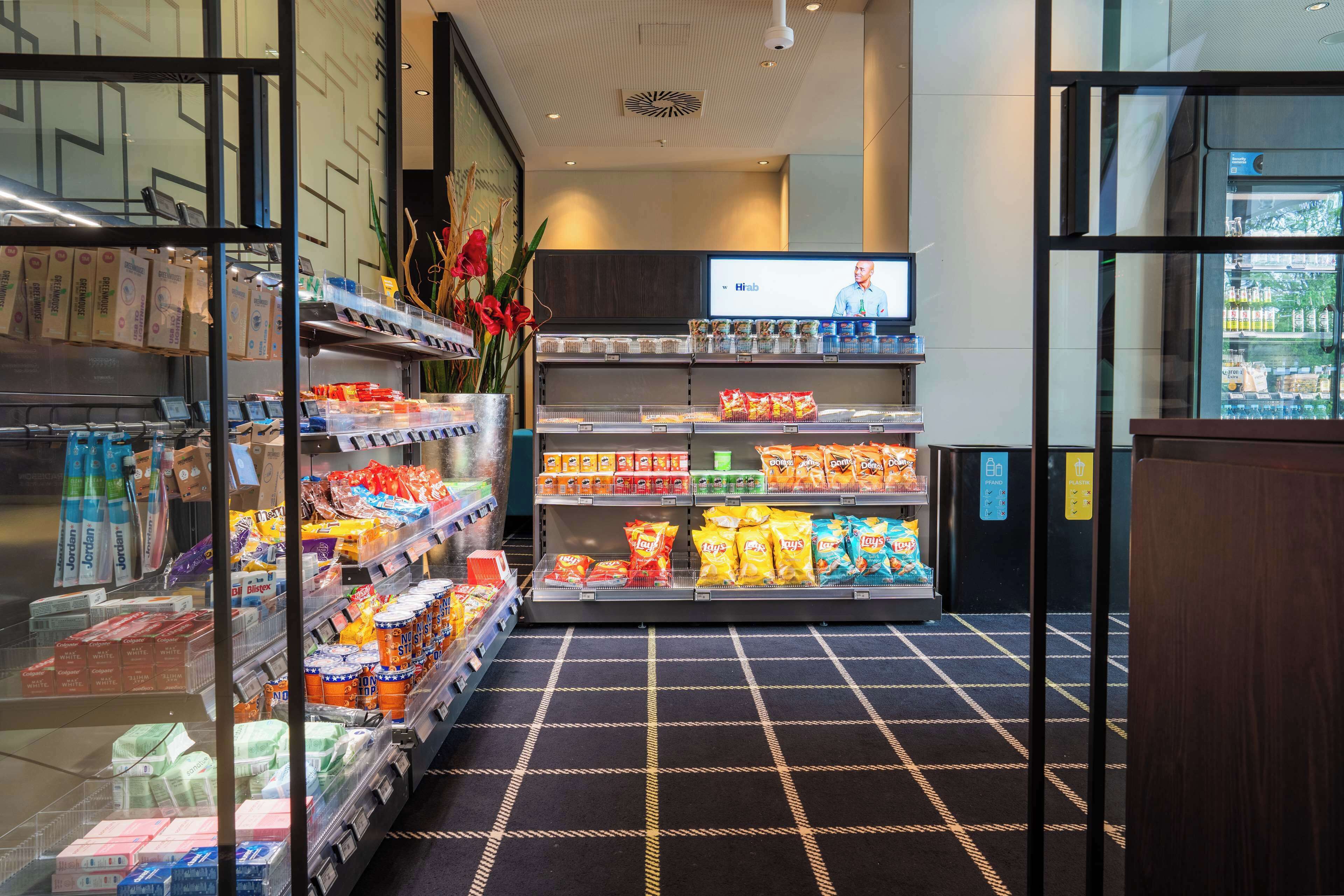 A grocery store with shelves stocked with snacks, beverages, and packaged goods.