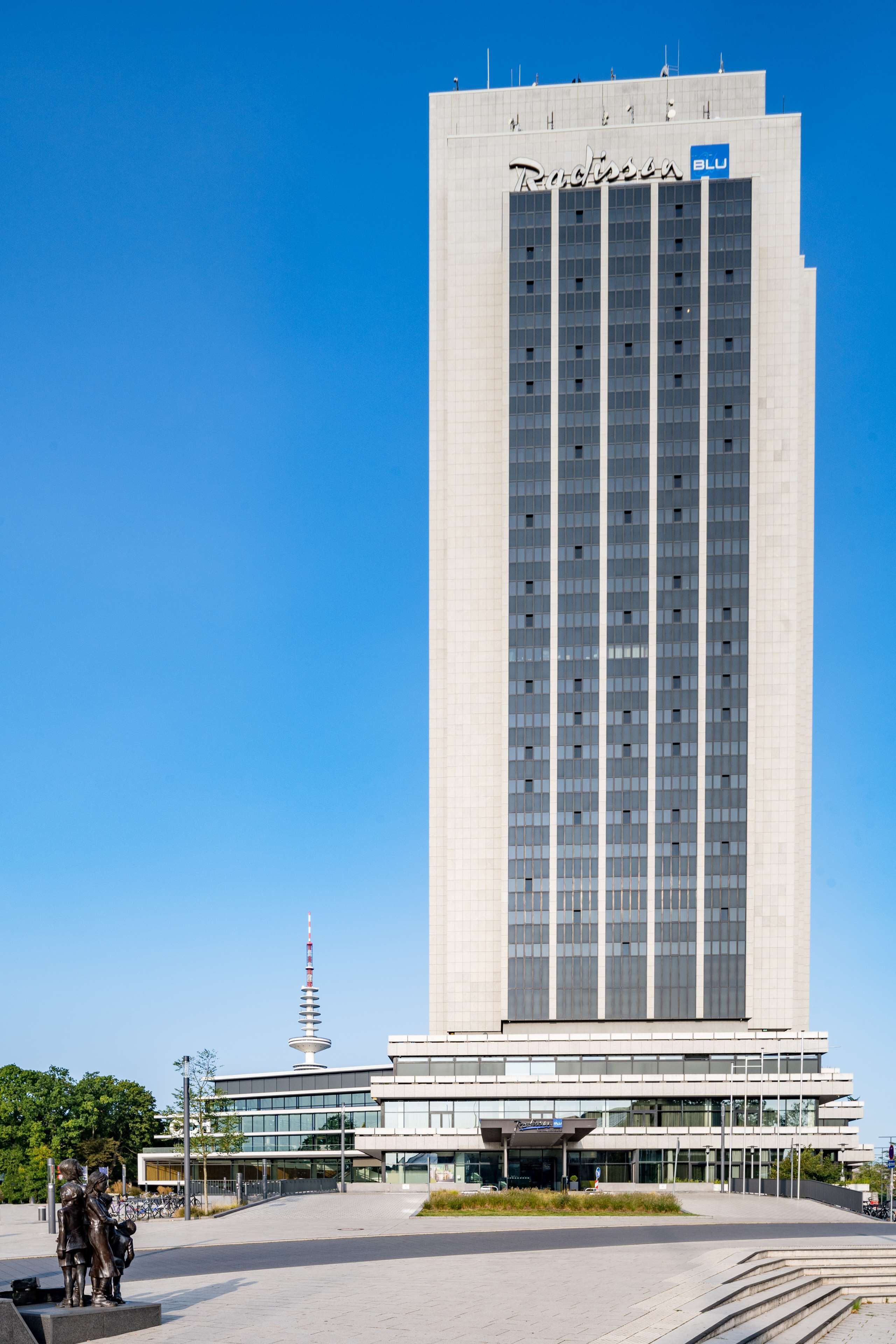 A tall, modern building with a sign reading "Radisson Blu".