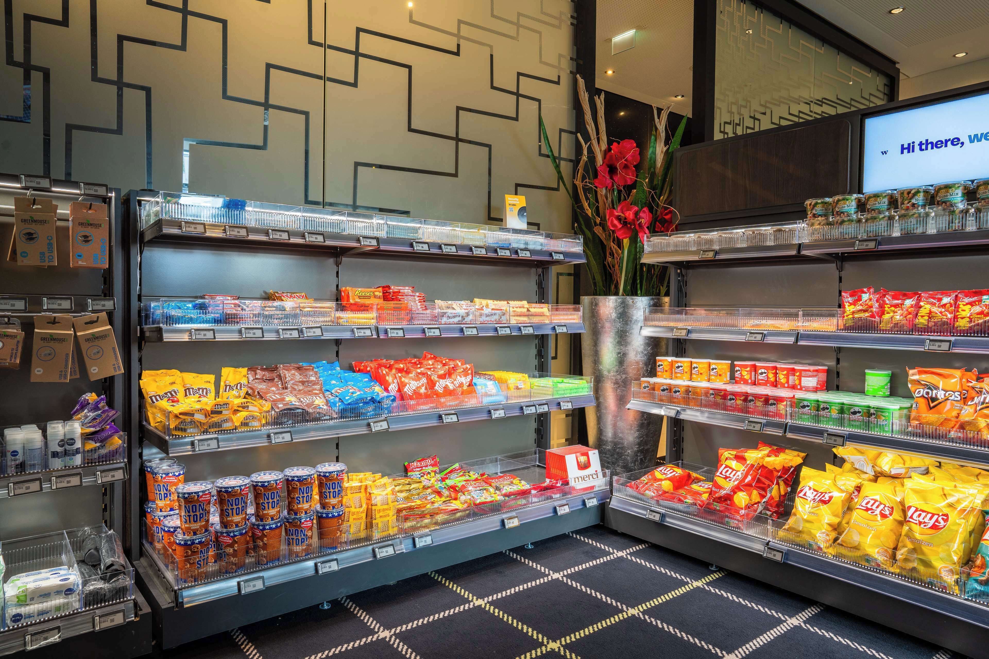 A grocery store with shelves stocked with snacks and beverages.