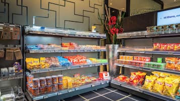 A grocery store with shelves stocked with snacks and beverages.