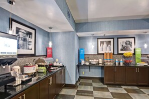 A modern kitchen with a coffee station, a buffet counter, and a refrigerator. - Hampton Inn State College (State College)