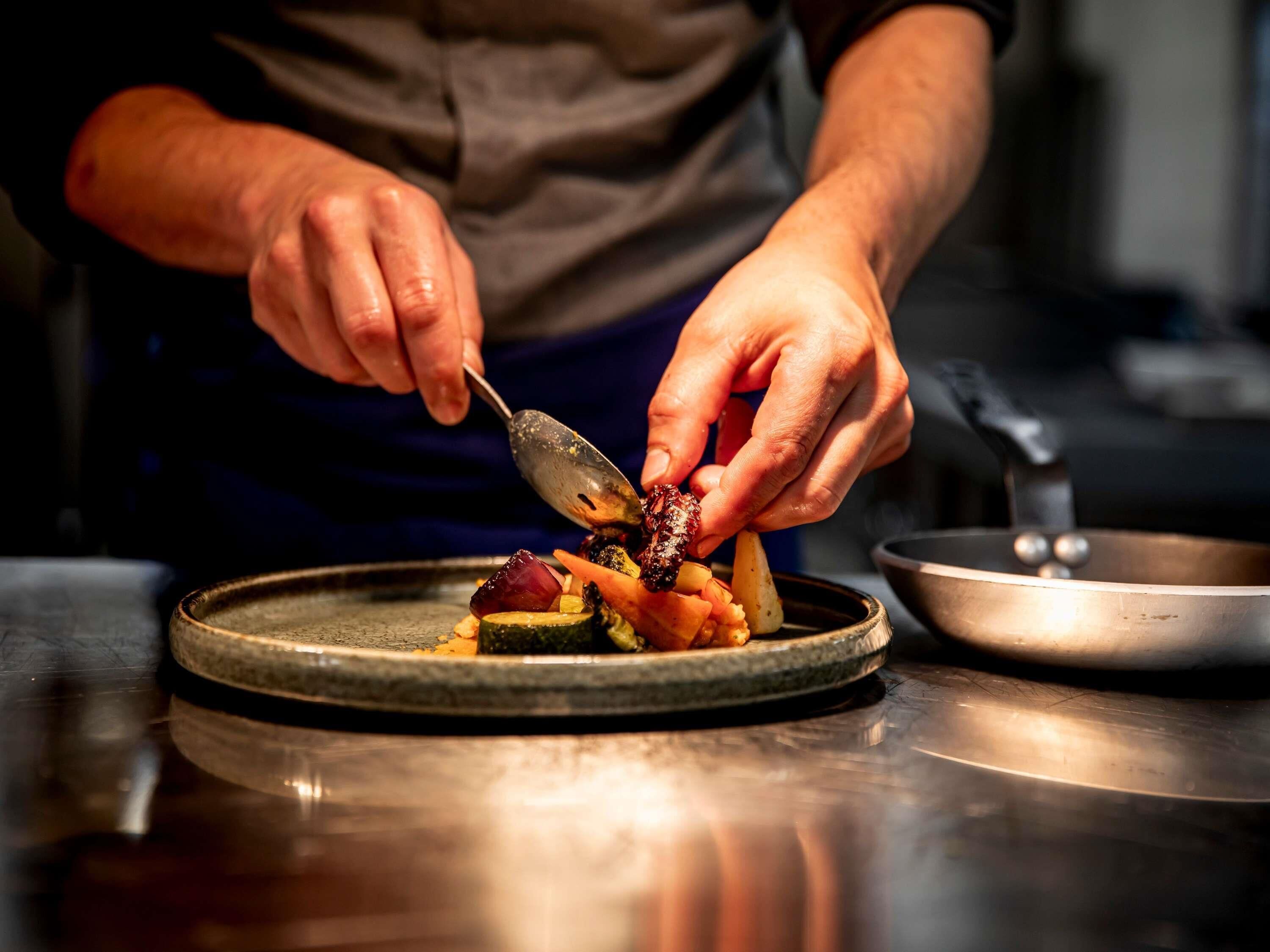 A person serving food on a plate.