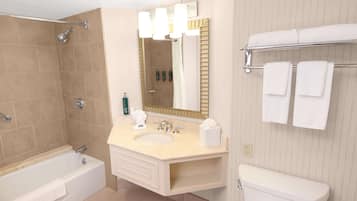 A modern bathroom with a bathtub, sink, and toilet.