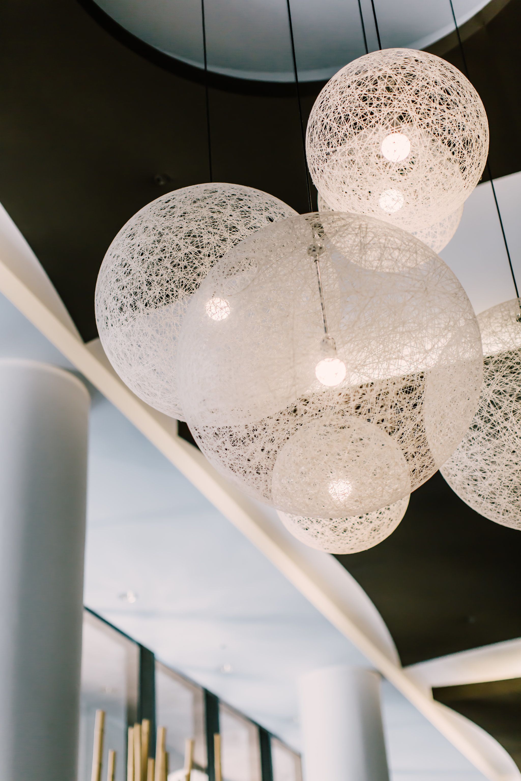 A modern chandelier with multiple spherical, translucent light fixtures.