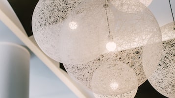 A modern chandelier with multiple spherical, translucent light fixtures.