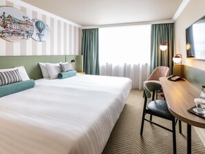 A hotel room with a large bed, a desk with a telephone, and a chair. - Mercure Northampton (Northampton)