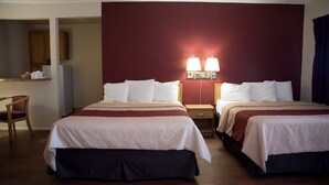 A hotel room with two beds, a desk, and a chair. - Red Roof Inn Blythe (Blythe)