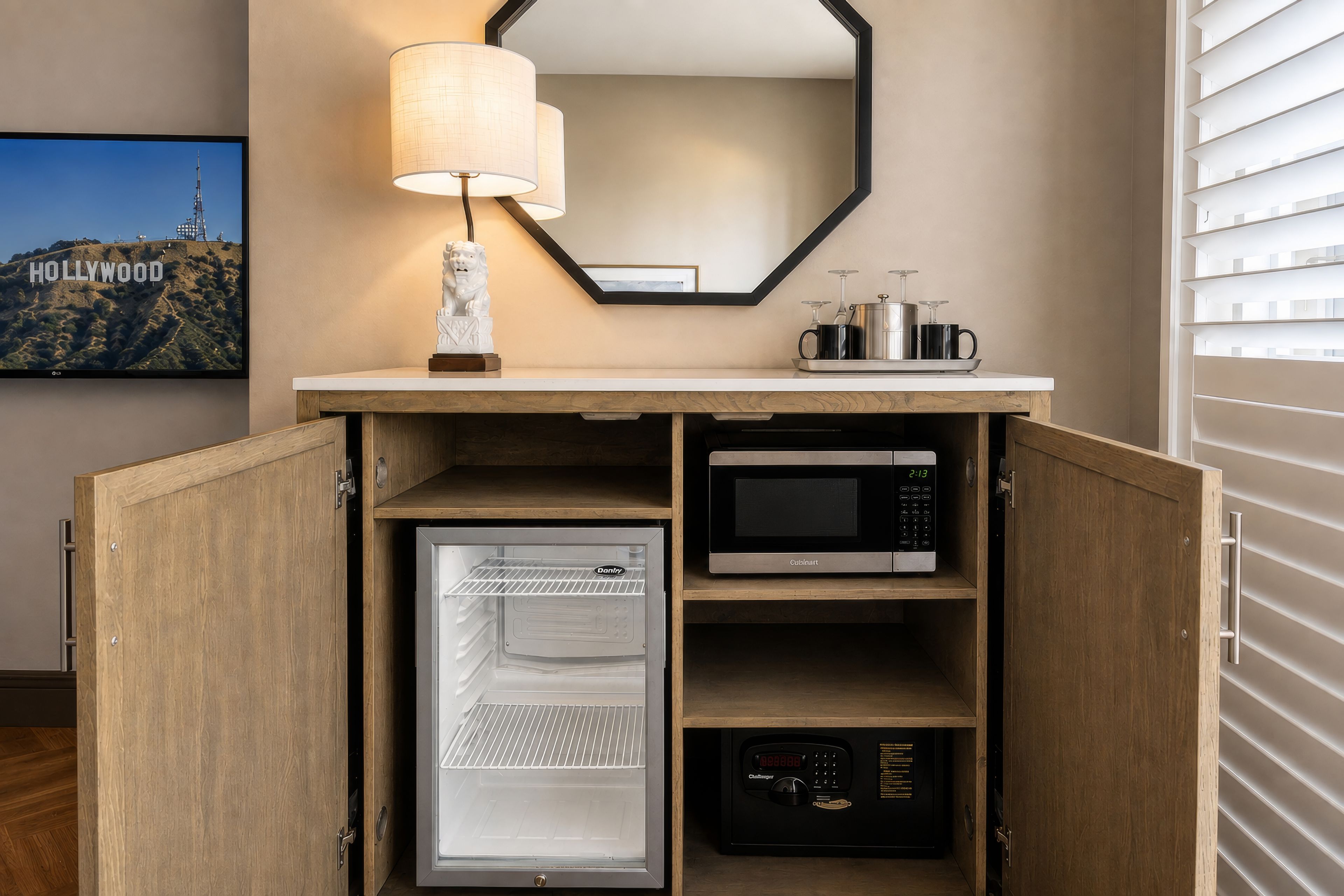 A compact kitchenette with a microwave, a refrigerator, and a coffee maker.
