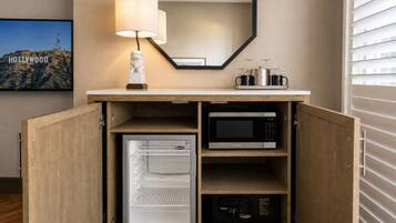 A compact kitchenette with a microwave, a refrigerator, and a coffee maker.