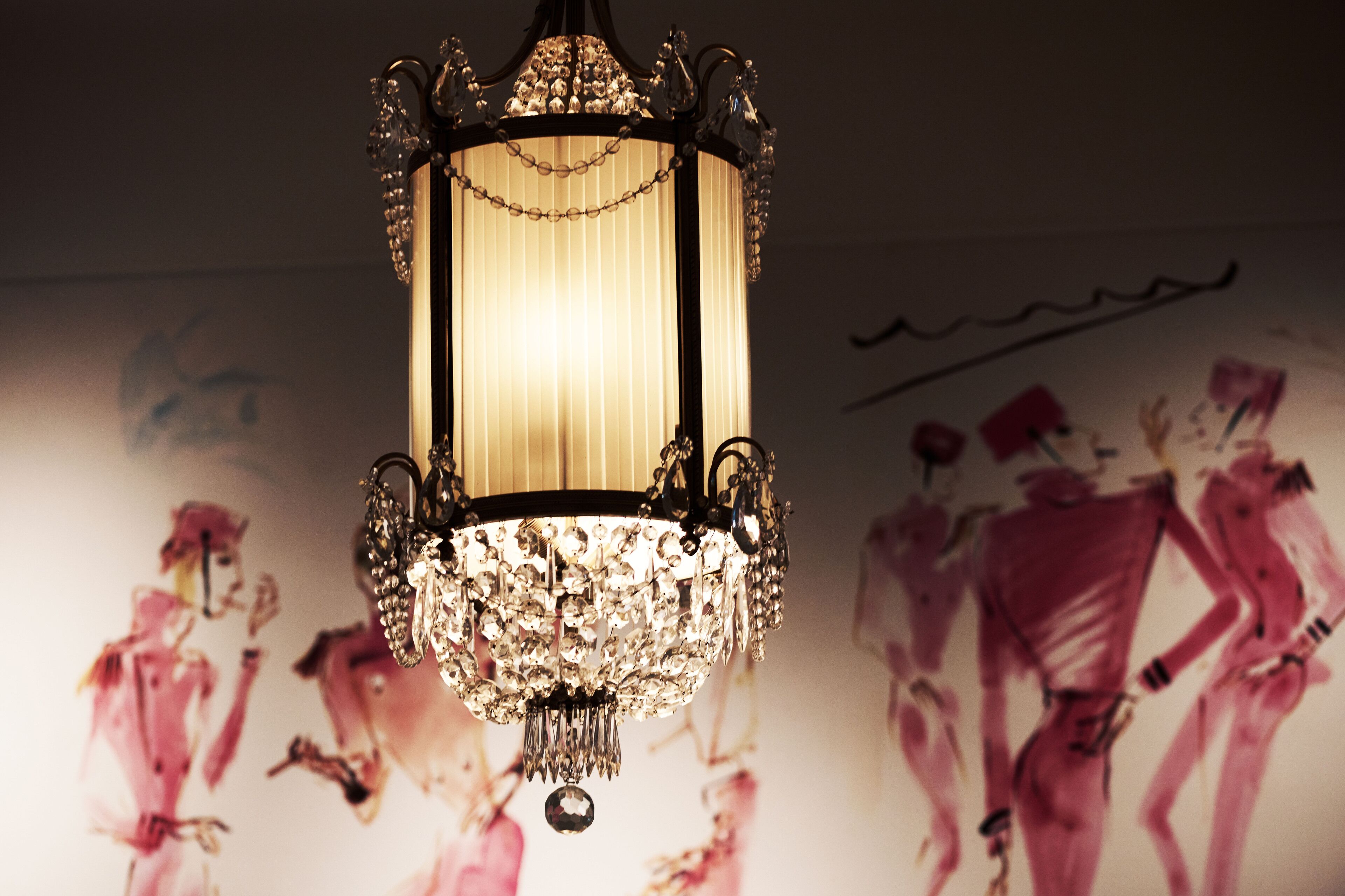 A chandelier with a chain of crystals hanging from it.
