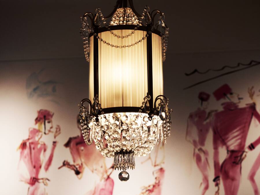 A chandelier with a chain of crystals hanging from it.