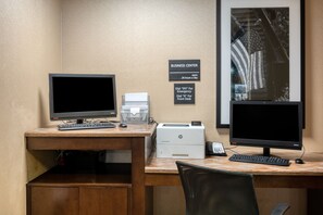 A business center with two computer monitors, a printer, and a desk with a chair. - Hampton Inn Janesville (Janesville)