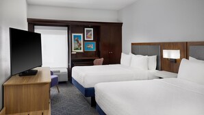 A hotel room with two beds, a TV, a desk, a chair, and a window with curtains. - Hampton Inn Janesville (Janesville)