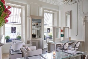 Relax in a spacious room with a comfortable sofa, dining table, and modern vanity.