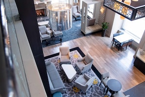 A hotel lobby with seating areas, a fireplace, and a staircase. - Hilton Chicago (Chicago)